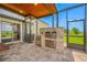 Covered outdoor kitchen with built-in grill, stainless steel storage, and views of the backyard at 31775 Sun Kettle Loop Loop, Wesley Chapel, FL 33545