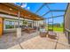 Large screened-in patio features an outdoor kitchen, dining area and comfortable outdoor seating at 31775 Sun Kettle Loop Loop, Wesley Chapel, FL 33545