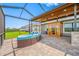 Relaxing screened patio with outdoor furniture and a charming sauna, perfect for entertaining at 31775 Sun Kettle Loop Loop, Wesley Chapel, FL 33545