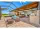 Expansive screened-in patio with outdoor seating, dining, and outdoor kitchen perfect for entertaining at 31775 Sun Kettle Loop Loop, Wesley Chapel, FL 33545