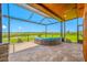 Relaxing screened-in patio featuring comfortable seating with picturesque water views at 31775 Sun Kettle Loop Loop, Wesley Chapel, FL 33545