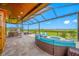 Spacious screened-in patio features an outdoor kitchen, dining and firepit lounge area with beautiful views at 31775 Sun Kettle Loop Loop, Wesley Chapel, FL 33545