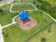 Aerial view of a playground featuring slides, shade structures, and convenient walking paths at 31775 Sun Kettle Loop Loop, Wesley Chapel, FL 33545