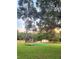 Expansive backyard with a trampoline, shed, and privacy fence, perfect for outdoor activities at 33516 Arthur Dr, Wesley Chapel, FL 33543