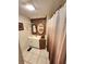 Compact bathroom with a vanity, framed mirrors, and a shower with a curtain at 33516 Arthur Dr, Wesley Chapel, FL 33543