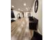 Spacious bonus room featuring tile floors, modern lighting, and comfortable wicker seating at 33516 Arthur Dr, Wesley Chapel, FL 33543