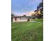 Charming single-story home featuring a red door, and a well-manicured front yard at 33516 Arthur Dr, Wesley Chapel, FL 33543