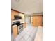 Kitchen with stainless steel appliances, light wood cabinets, and bright tile floors at 33516 Arthur Dr, Wesley Chapel, FL 33543
