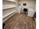 Spacious laundry room with wood-look tile flooring, shelving, washer and dryer at 33516 Arthur Dr, Wesley Chapel, FL 33543