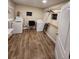 Bright laundry room with wood look flooring, washer, dryer, and shelving at 33516 Arthur Dr, Wesley Chapel, FL 33543
