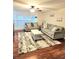 Bright living room features natural light, ceiling fan, hardwood floors, and comfortable seating at 33516 Arthur Dr, Wesley Chapel, FL 33543