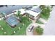 Waterfront home with screened pool, boat dock, lush landscaping, and circular driveway at 3654 Corsair Ct, New Port Richey, FL 34652