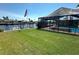 Waterfront backyard with pool, dock, boat and expansive lawn, perfect for entertaining at 3654 Corsair Ct, New Port Richey, FL 34652