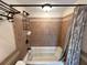 Bathroom tub with tiled wall and shower curtain at 3654 Corsair Ct, New Port Richey, FL 34652
