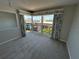Bedroom with carpet, corner windows, and tropical decor at 3654 Corsair Ct, New Port Richey, FL 34652