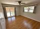 Bright bedroom with wood floors, tropical curtains, and natural light at 3654 Corsair Ct, New Port Richey, FL 34652