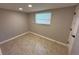 This is a view of the bedroom, which has a window and neutral-colored walls and flooring at 3654 Corsair Ct, New Port Richey, FL 34652