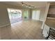 Bright dining room features tile floors, track lighting, and sliding glass doors to the waterfront patio at 3654 Corsair Ct, New Port Richey, FL 34652