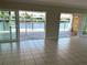 Spacious dining room boasts beautiful tile floors and sliding glass doors to the waterfront patio at 3654 Corsair Ct, New Port Richey, FL 34652