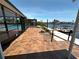 Paver patio leads to screened lanai, pool, and boat dock with scenic waterfront views at 3654 Corsair Ct, New Port Richey, FL 34652
