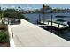 Waterfront home boasts dock with boat lift, outdoor dining, and patio for entertaining at 3654 Corsair Ct, New Port Richey, FL 34652