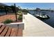 Paver patio and stairs leading to boat dock with boat lift on the canal at 3654 Corsair Ct, New Port Richey, FL 34652