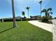 Beautiful home with mature palms, manicured lawn, circular driveway and waterfront views at 3654 Corsair Ct, New Port Richey, FL 34652