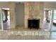 Stone fireplace with protective screen flanked by sliders to backyard pool and canal at 3654 Corsair Ct, New Port Richey, FL 34652