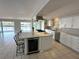 Open kitchen features stainless steel appliances, large island, and breakfast bar seating at 3654 Corsair Ct, New Port Richey, FL 34652