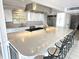 Elegant kitchen with white cabinets, quartz countertops, and stainless steel appliances, plus a large island at 3654 Corsair Ct, New Port Richey, FL 34652