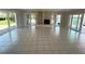 Bright, open living room featuring tile floors, fireplace, and sliding glass doors to waterfront views at 3654 Corsair Ct, New Port Richey, FL 34652
