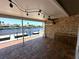 Covered patio includes brick pavers, track lighting, ceiling fan, and waterfront views at 3654 Corsair Ct, New Port Richey, FL 34652