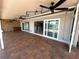 Extended covered patio offers brick pavers, ceiling fans, and access to the home's interior at 3654 Corsair Ct, New Port Richey, FL 34652