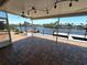 Waterfront patio features brick pavers, ceiling fan, and beautiful views of the canal and docks at 3654 Corsair Ct, New Port Richey, FL 34652