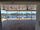 Covered patio with beautiful waterfront views, including boat docks and palm trees at 3654 Corsair Ct, New Port Richey, FL 34652
