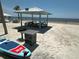 Beach pavilion featuring picnic tables, a grill and a paddleboard for enjoying a relaxed day by the water at 3654 Corsair Ct, New Port Richey, FL 34652