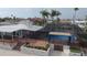 Screened pool and outdoor entertainment area with brick pavers and lush landscaping at 3654 Corsair Ct, New Port Richey, FL 34652
