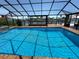 Screened-in pool offers privacy and stunning views of the surrounding waterfront community at 3654 Corsair Ct, New Port Richey, FL 34652