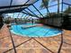Screened pool with brick pavers, water feature, and serene waterfront views at 3654 Corsair Ct, New Port Richey, FL 34652