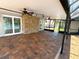 Spacious pool room with brick floor, stone accent wall, and screened windows for natural light at 3654 Corsair Ct, New Port Richey, FL 34652