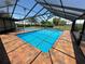 Screened in-ground pool with brick pavers and a picturesque waterfront view at 3654 Corsair Ct, New Port Richey, FL 34652