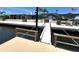 Inviting waterfront home featuring a private dock, fire pit, and ample outdoor seating, ideal for relaxation and entertainment at 3654 Corsair Ct, New Port Richey, FL 34652
