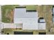 An aerial view shows the expansive roof and the surrounding landscape that features a driveway and grassy areas at 36750 Beth Ave, Zephyrhills, FL 33542