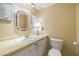 Bathroom features a vanity with updated fixtures and an adjacent toilet at 36750 Beth Ave, Zephyrhills, FL 33542