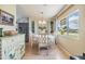 Cozy dining room with a round table, decorative china cabinet and natural light streaming through a large window at 36750 Beth Ave, Zephyrhills, FL 33542