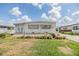 Charming home with a well-manicured lawn, complemented by bright sky, features a quaint and inviting curb appeal at 36750 Beth Ave, Zephyrhills, FL 33542