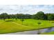 Beautiful green golf course with mature trees, a winding waterway, and perfectly manicured grass at 36750 Beth Ave, Zephyrhills, FL 33542