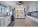 Bright kitchen featuring an island, stainless steel appliances and granite countertops, with a view into the dining area at 36750 Beth Ave, Zephyrhills, FL 33542