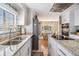 A sleek kitchen with granite countertops, stainless steel appliances, and wood floors creates a modern and functional space at 36750 Beth Ave, Zephyrhills, FL 33542