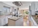 Modern kitchen features granite countertops, stainless steel appliances, and a seamless flow into the light-filled dining area at 36750 Beth Ave, Zephyrhills, FL 33542